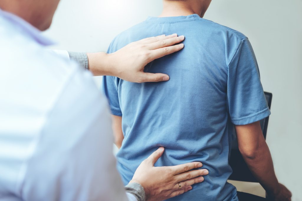 Doctor consulting with patient Back problems Physical therapy co